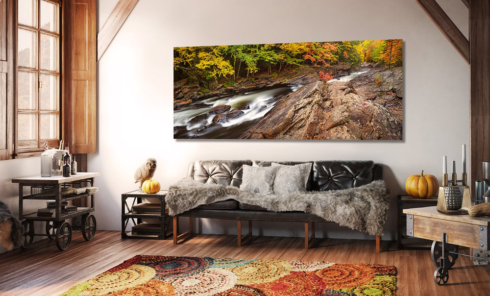 Living Room with wood decor, dark couch, oversize photo art wall hanging of natural creek